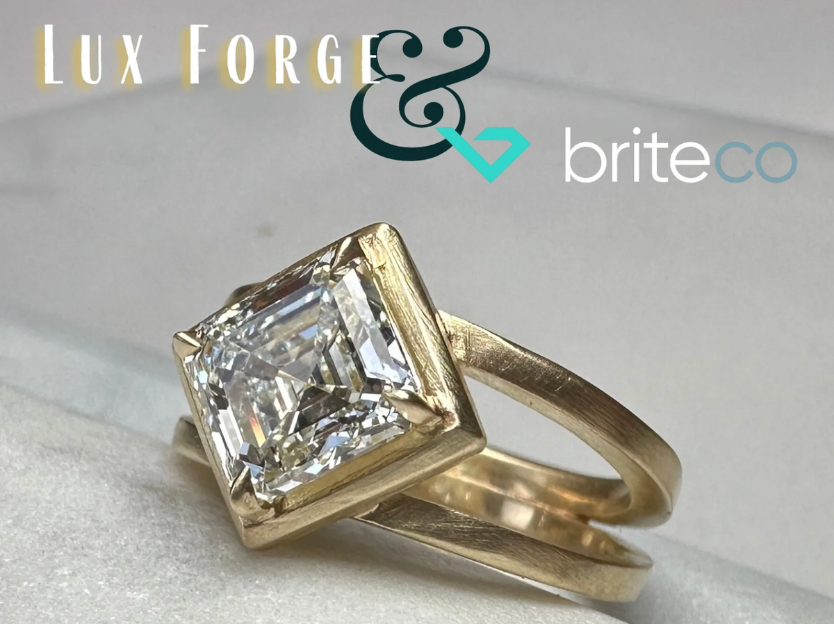 Gold ring with a large diamond on a light background, featuring Lux Forge and BriteCo logos.